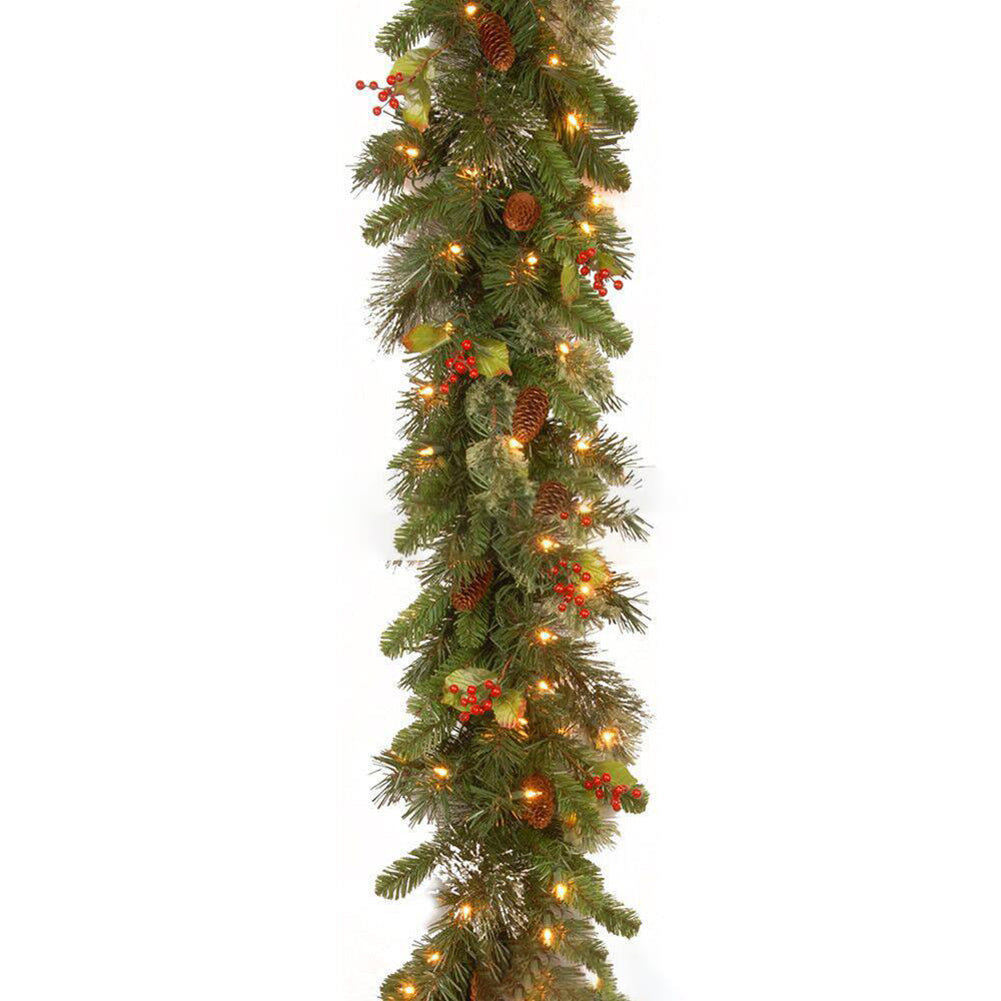Christmas garland with lights and berries on a white background