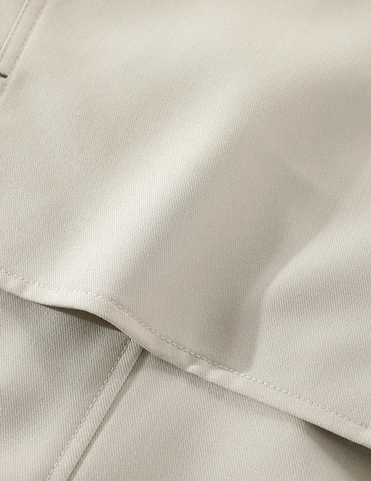 Close-up of beige fabric with a focus on texture and stitching.