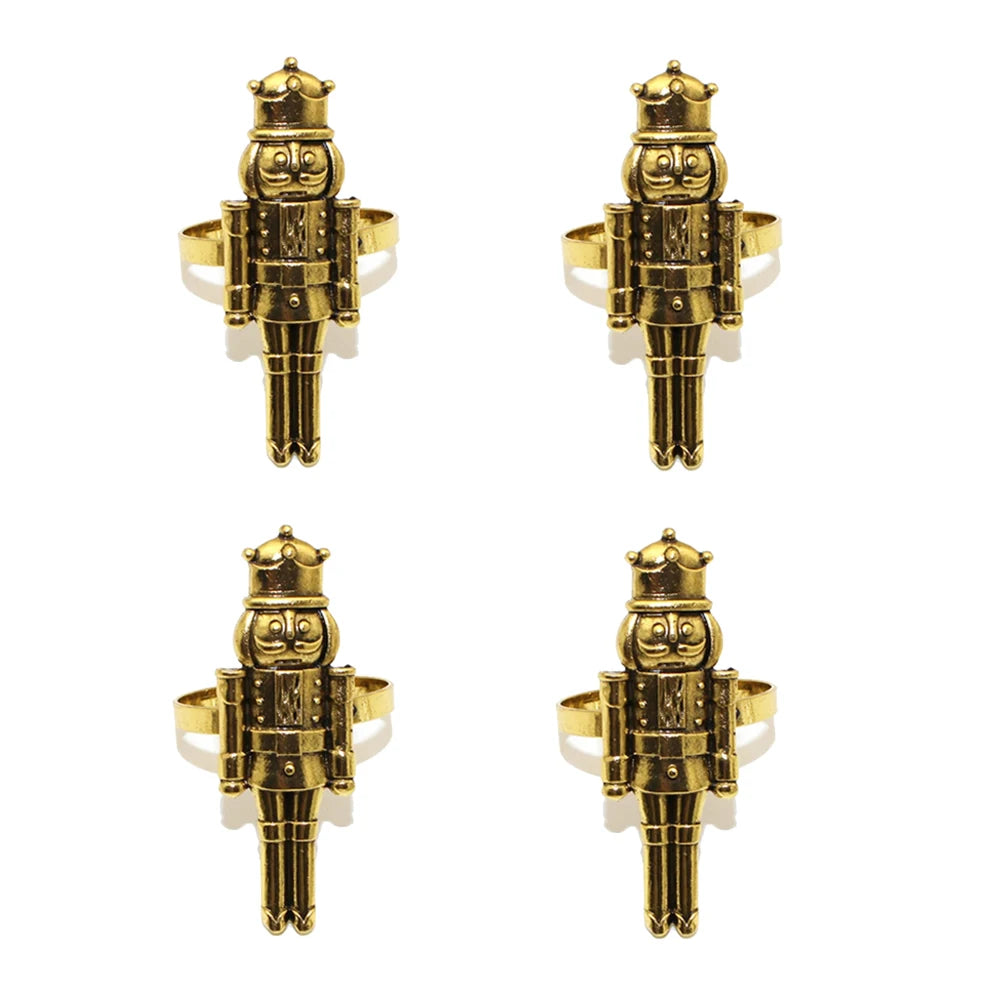 Four gold nutcracker-shaped rings on a white background