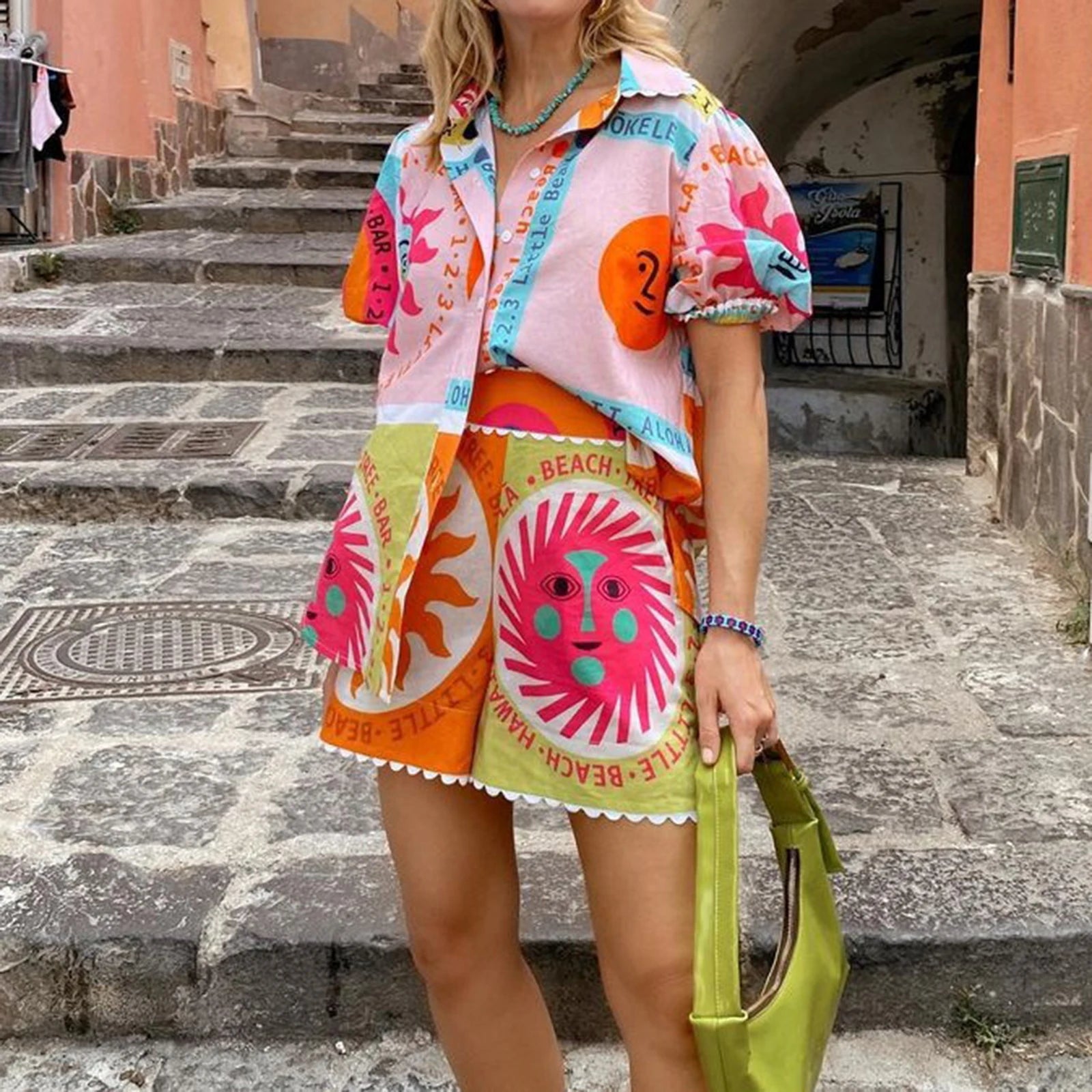 Person wearing a colorful outfit with a beach-themed skirt and holding a green bag on stone steps.