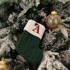 Green Christmas stocking with a red letter 'A' on a decorated tree
