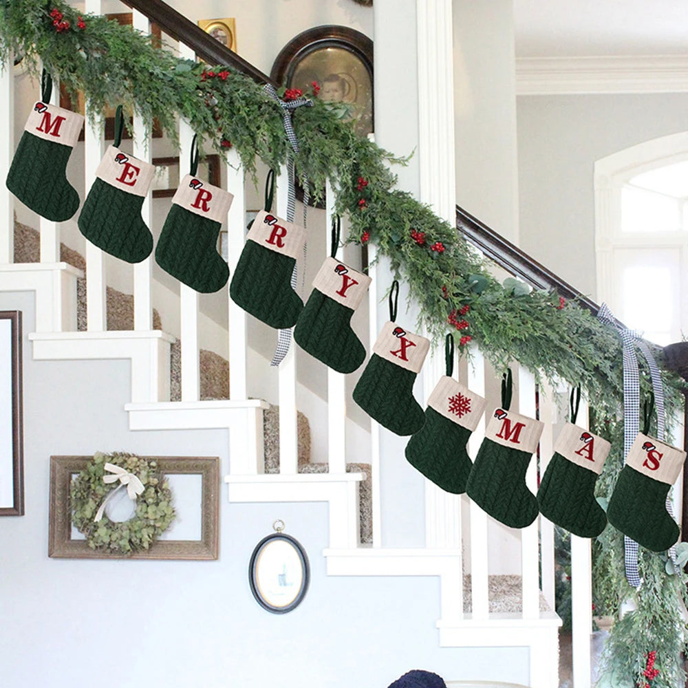 Decorative stockings with Christmas-themed designs hanging on a staircase.