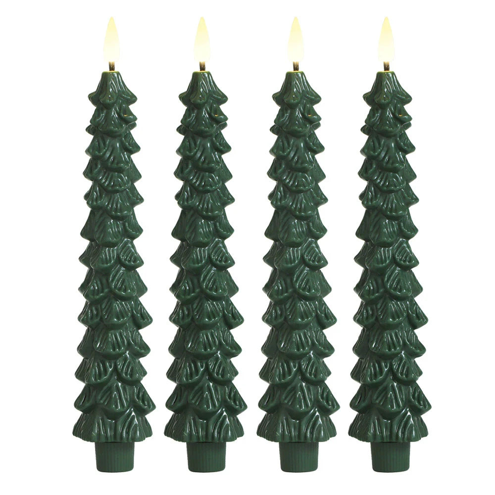 Four green tree-shaped candles with lit wicks on a white background
