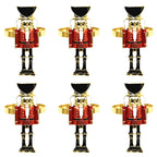 Set of six nutcracker-shaped napkin rings on a white background