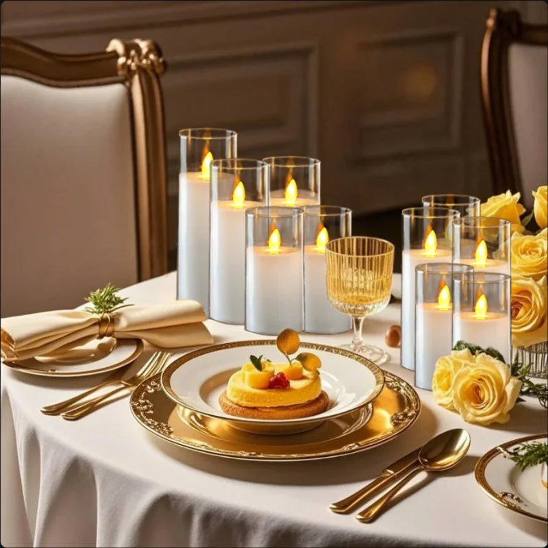 Elegant table setting with candles, gold glasses, and yellow flowers.