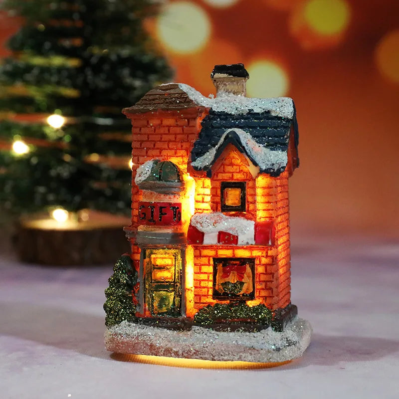Decorative Christmas house with glowing interior lights on a snowy base.