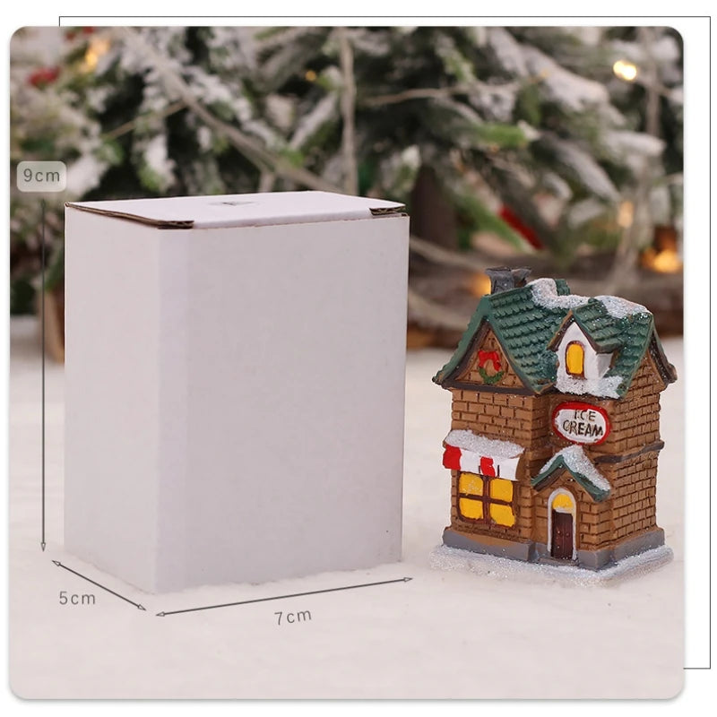 Small ice cream shop model with snow on top, next to a white box with dimensions, against a Christmas tree background.