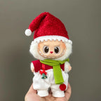 Toy figure of a character wearing a red Santa hat, red vest, and green scarf on a gray background.