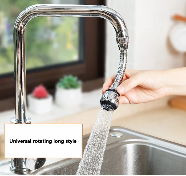 Chrome kitchen faucet with a hand holding the flexible hose, water flowing from it, in a kitchen setting.