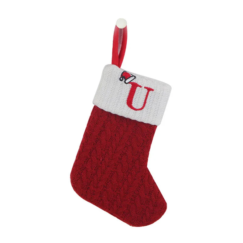 Red Christmas stocking with white cuff featuring a letter 'U' on a white background