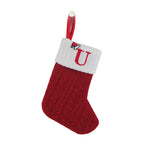 Red Christmas stocking with white cuff featuring a letter 'U' on a white background
