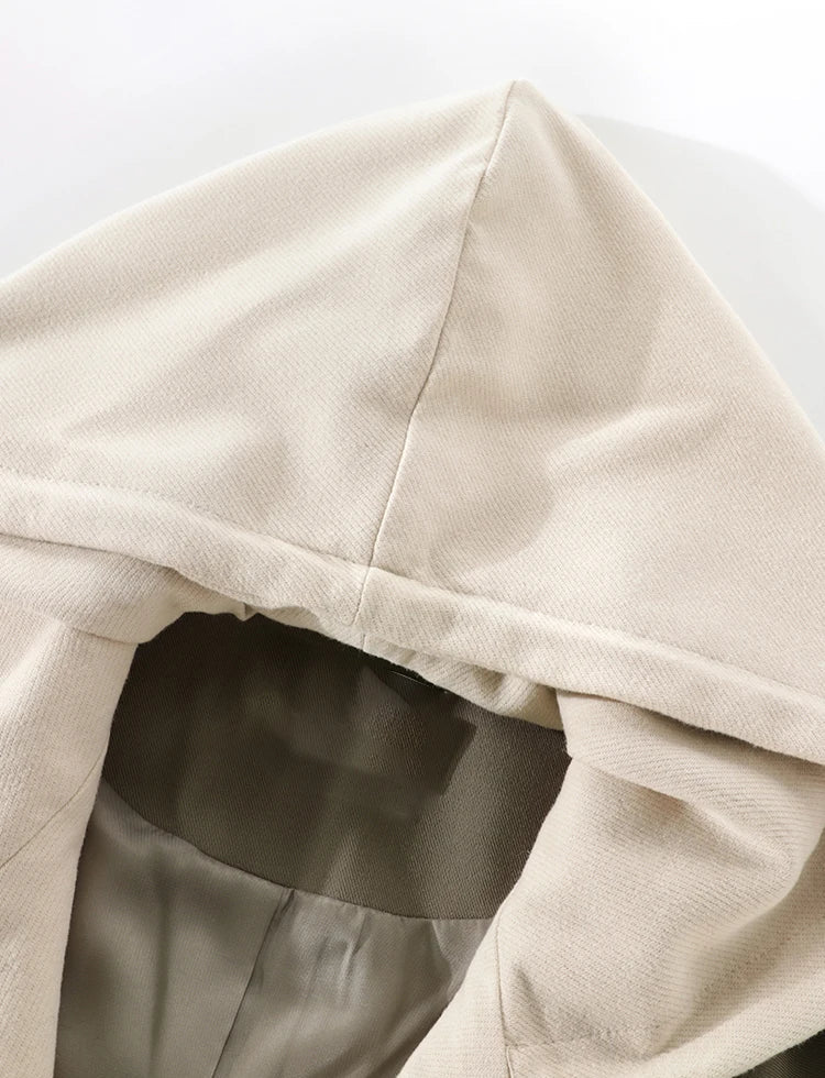 Close-up of a beige hooded garment on a white background