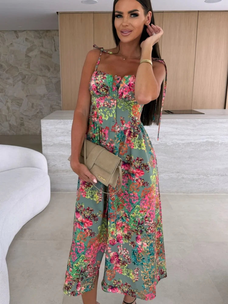Woman wearing a floral jumpsuit in a modern indoor setting