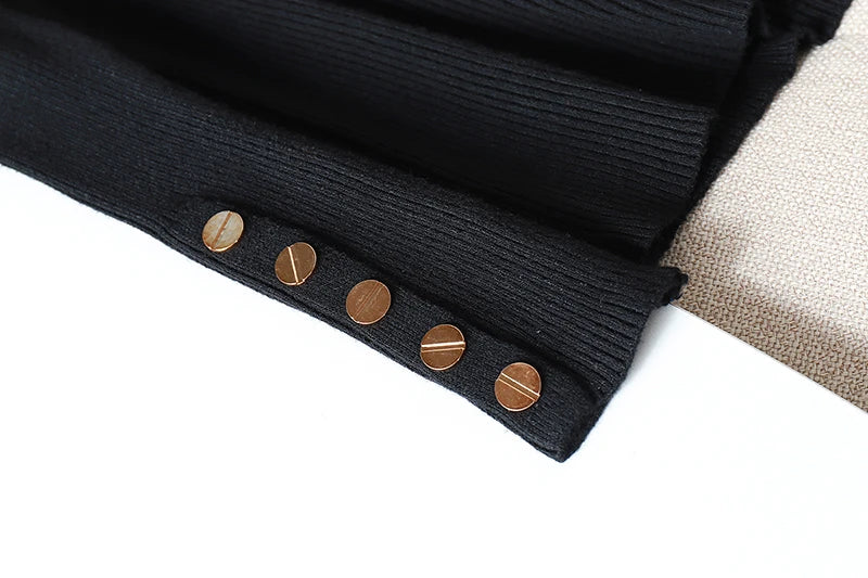 Close-up of a black ribbed fabric with gold buttons on a white background
