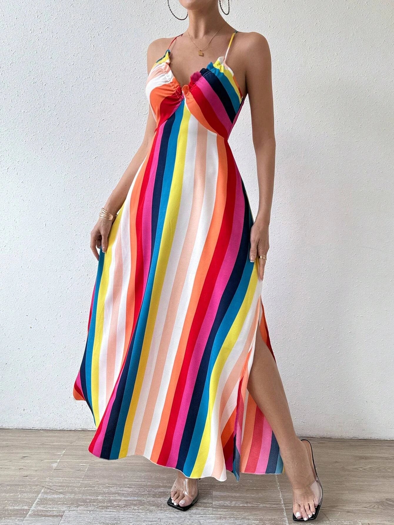 Woman wearing a colorful striped dress against a white background